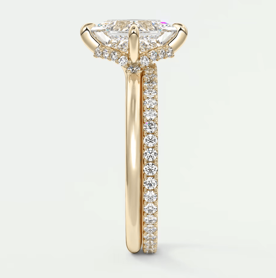 18k yellow gold engagement ring with a marquise-cut diamond center stone and pavé-set diamonds on the band.