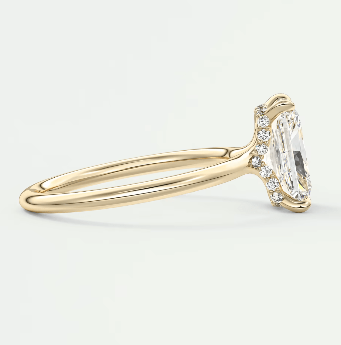 18k yellow gold engagement ring with marquise-cut diamond and small side diamonds.