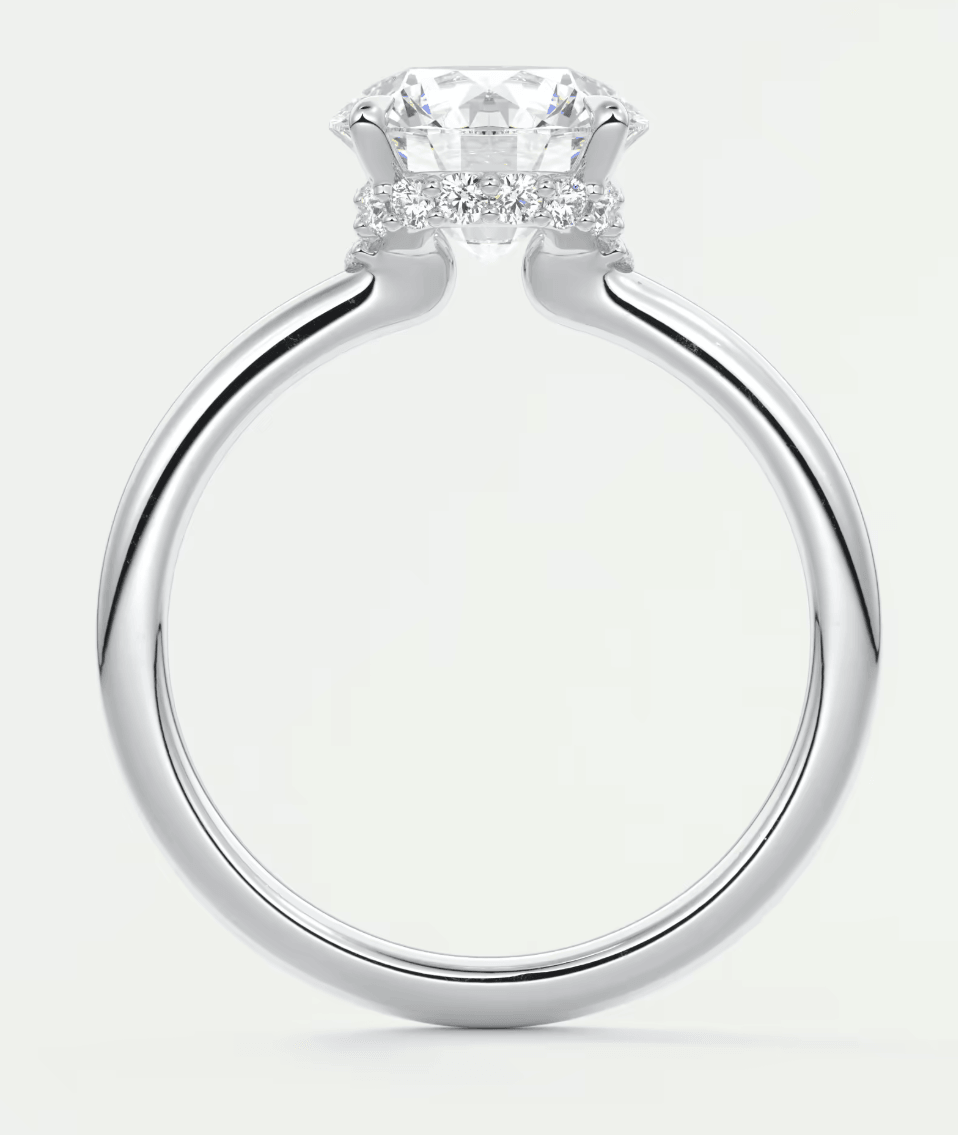 Silver diamond engagement ring with a halo design and prong setting.