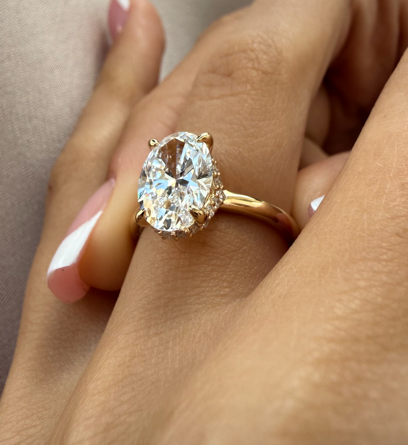 Gold ring with a large diamond on a hand