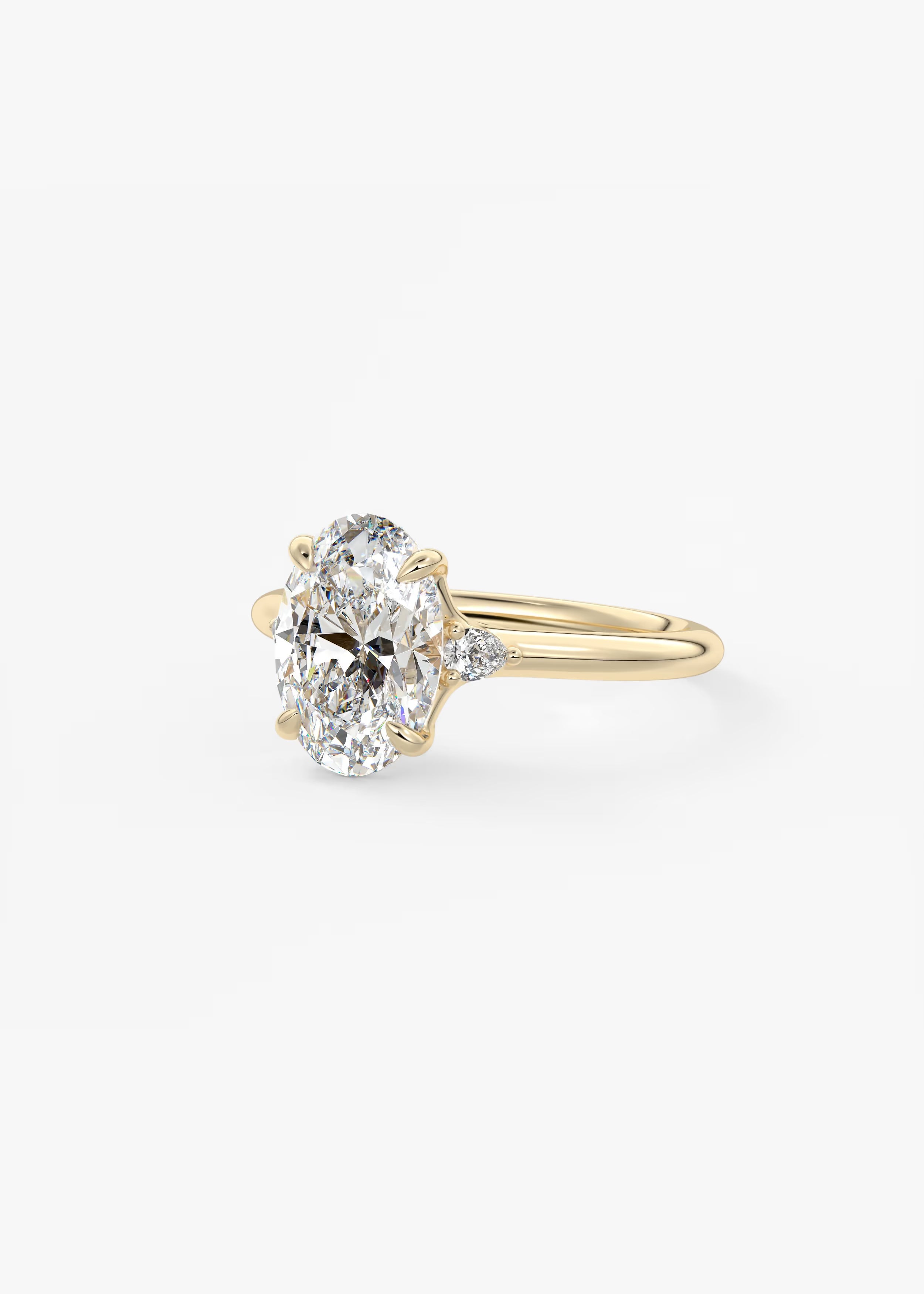 Cassia – Oval Trilogy with Pear Side Stones