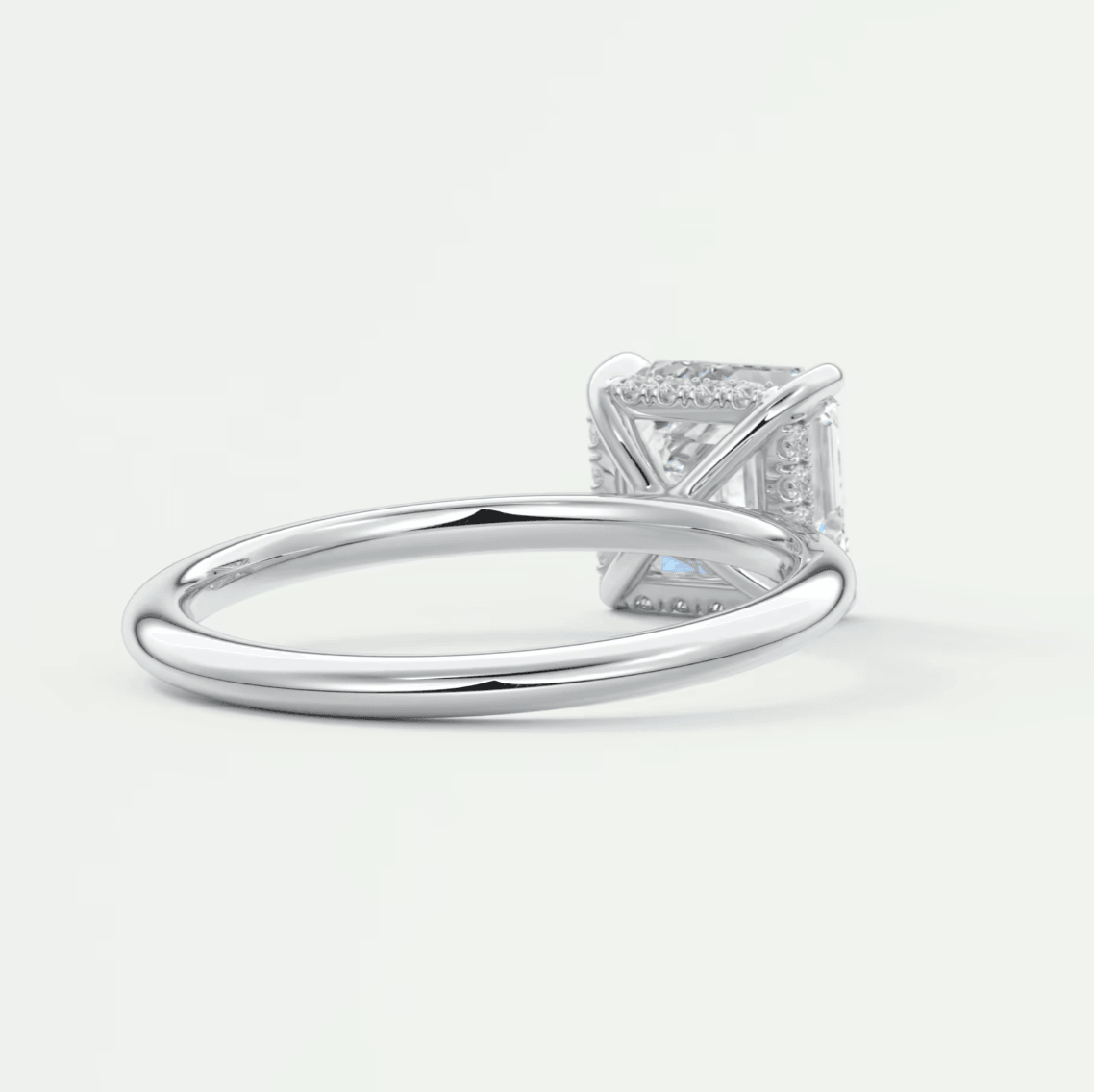 Princess cut diamond engagement ring with white gold band and halo of smaller diamonds.
