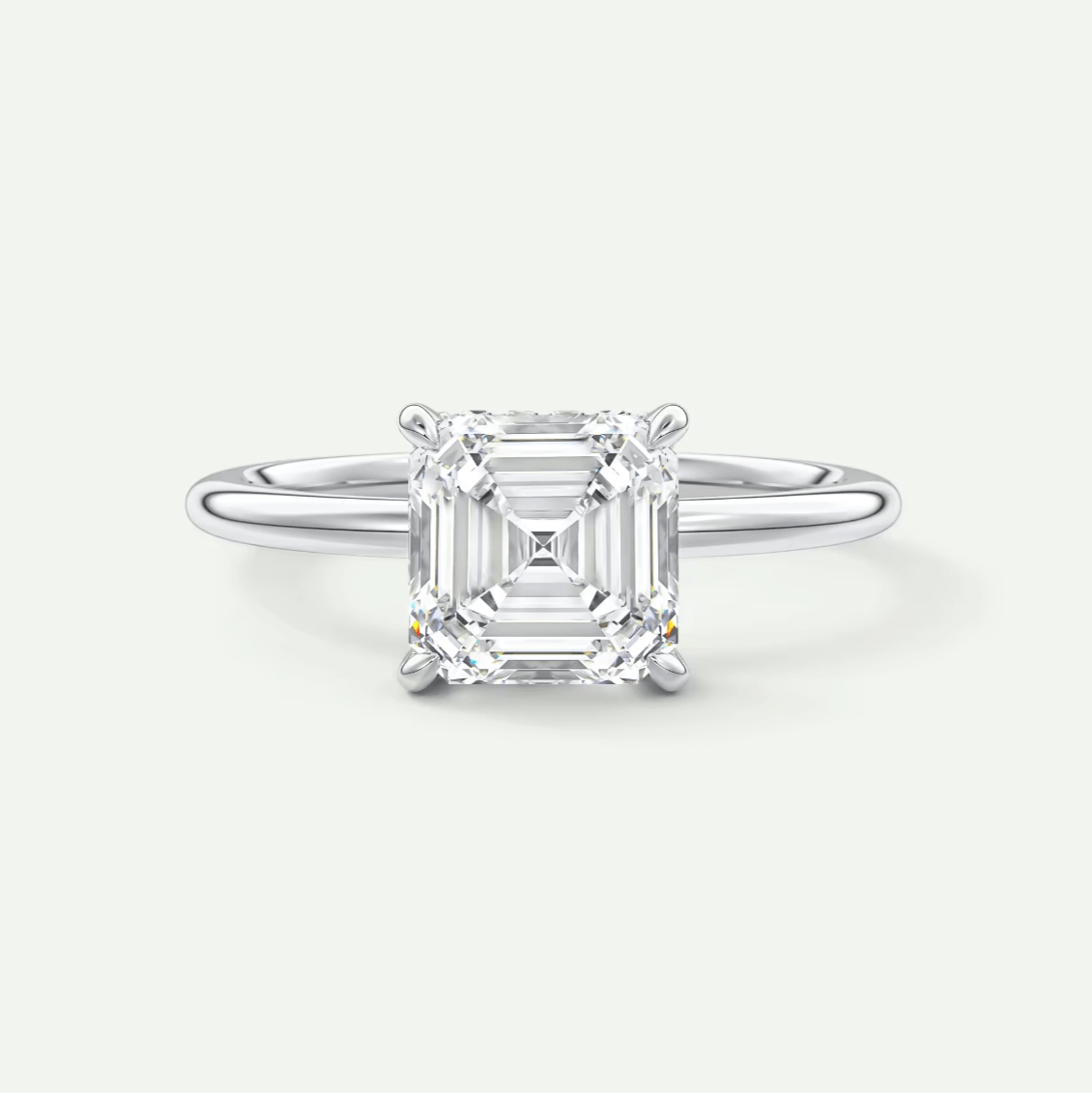 Asscher cut diamond engagement ring with white gold band.
