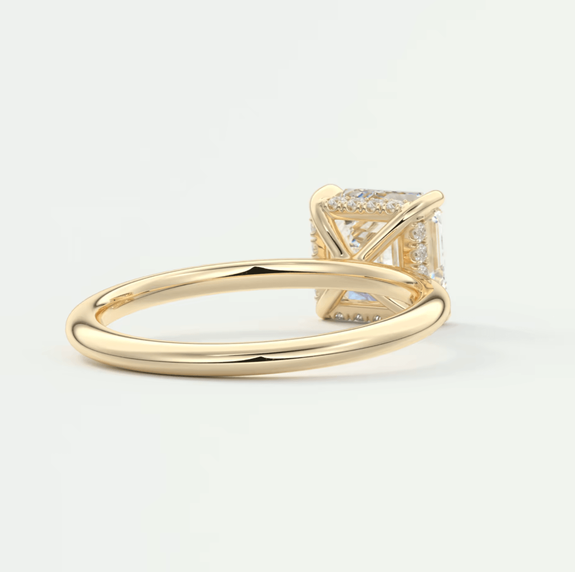 18k yellow gold princess cut diamond engagement ring with pave set diamonds on the band.