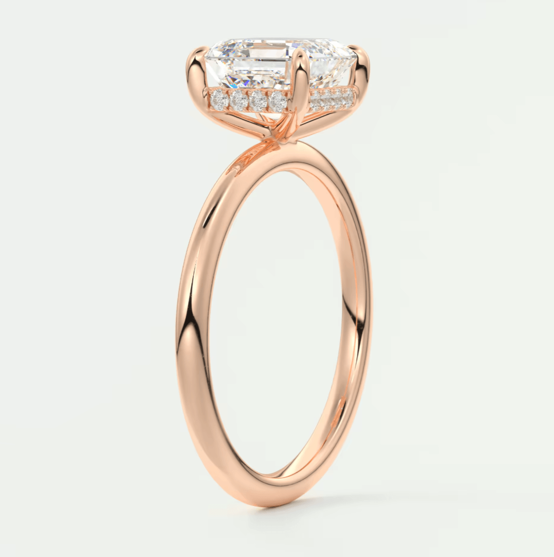 18k rose gold engagement ring with a princess cut diamond and baguette side stones.