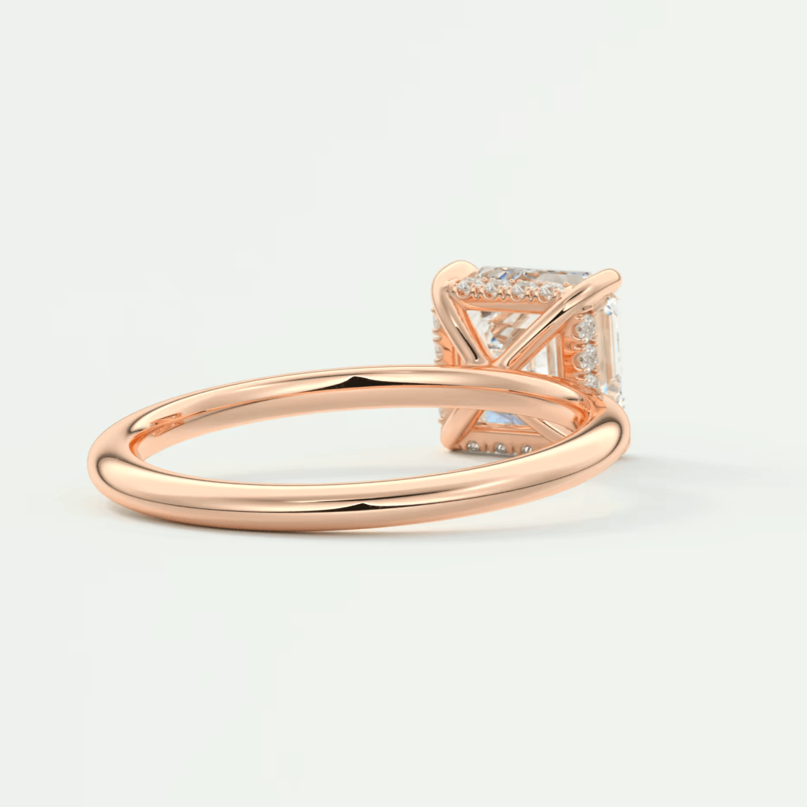 Rose gold princess cut diamond engagement ring with a delicate band design.