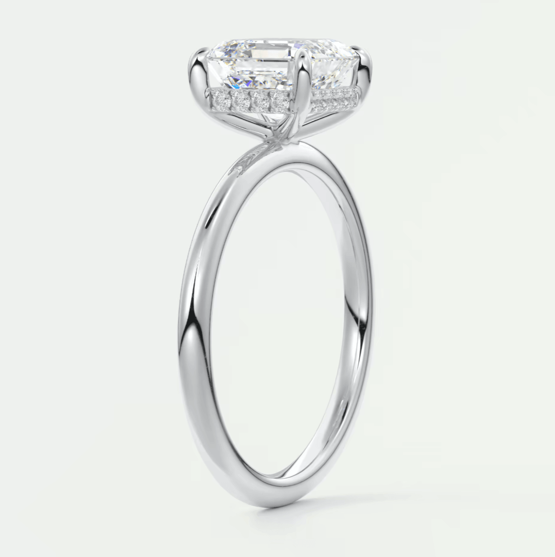 18k white gold engagement ring with a princess cut diamond and halo of smaller diamonds.