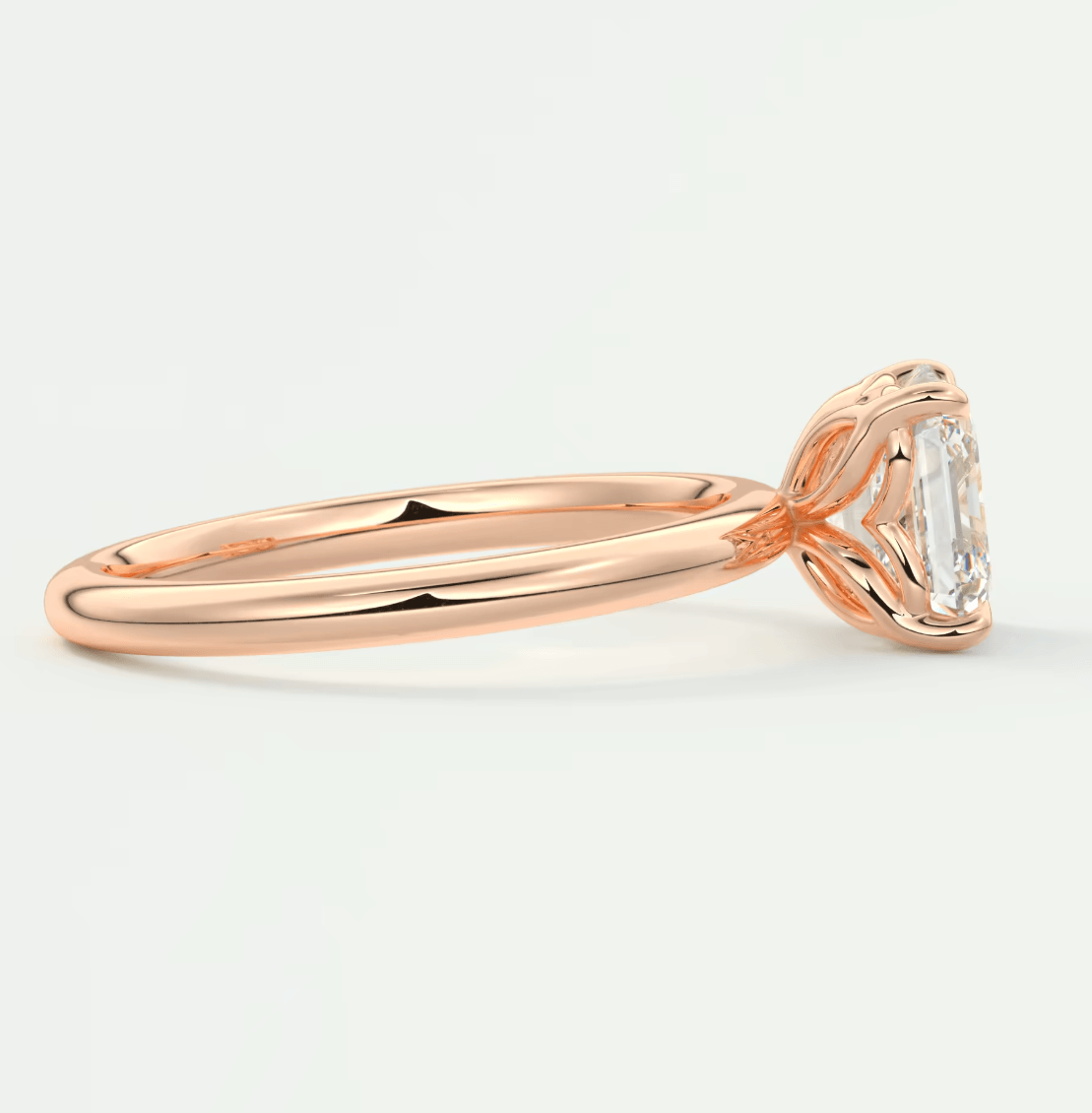 18k rose gold engagement ring with an emerald-cut diamond.