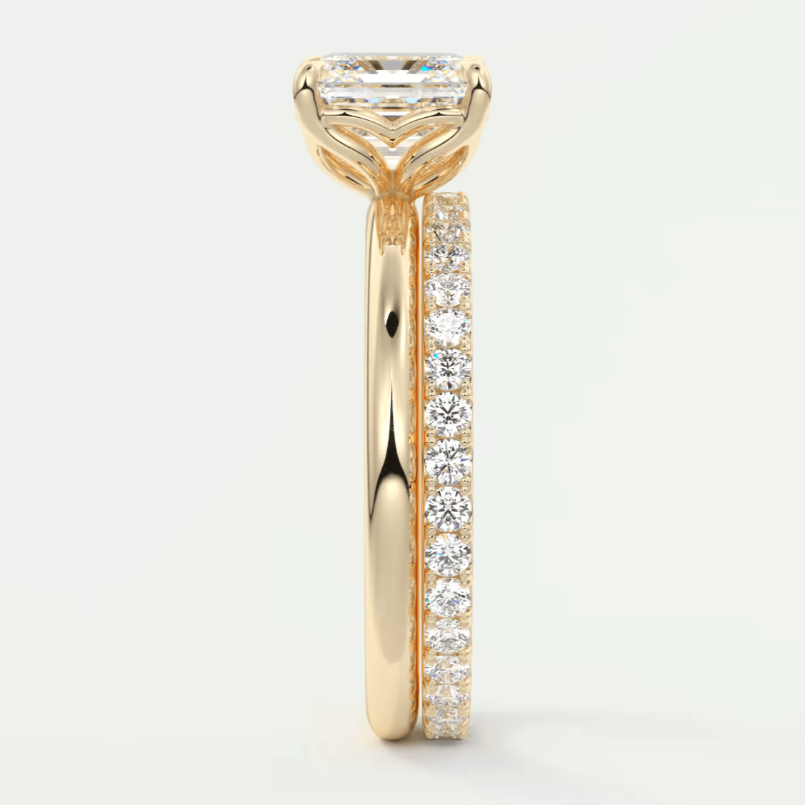 18k yellow gold engagement ring with a princess cut diamond and pave set diamonds on the band.