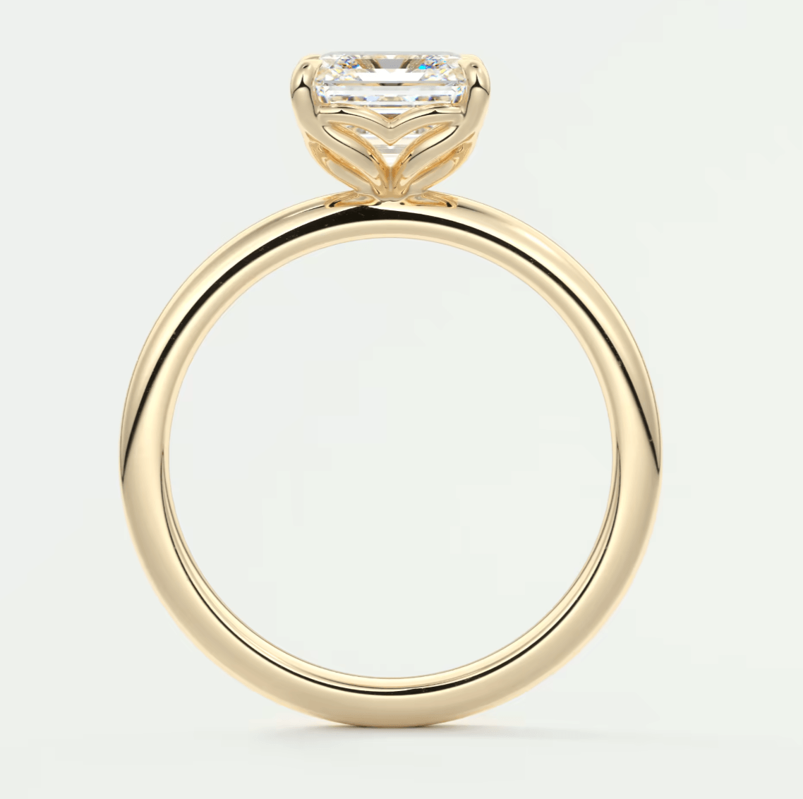 18-karat yellow gold engagement ring with a princess-cut diamond.