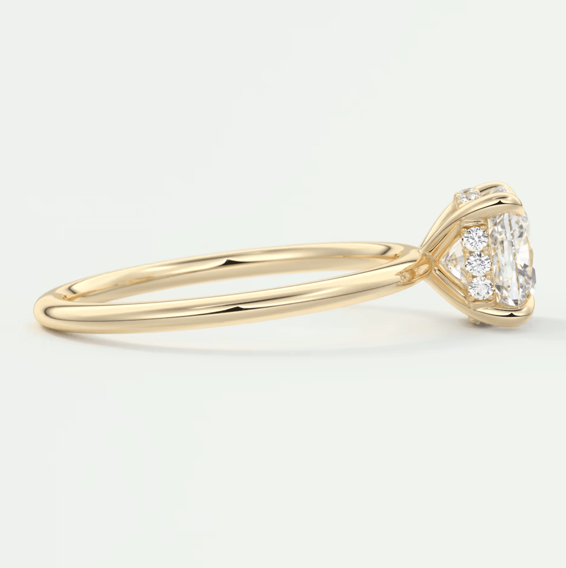 18k yellow gold engagement ring with a princess cut diamond and halo of smaller diamonds.