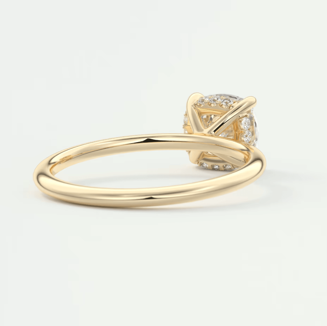 18k yellow gold engagement ring with a cushion-cut diamond.