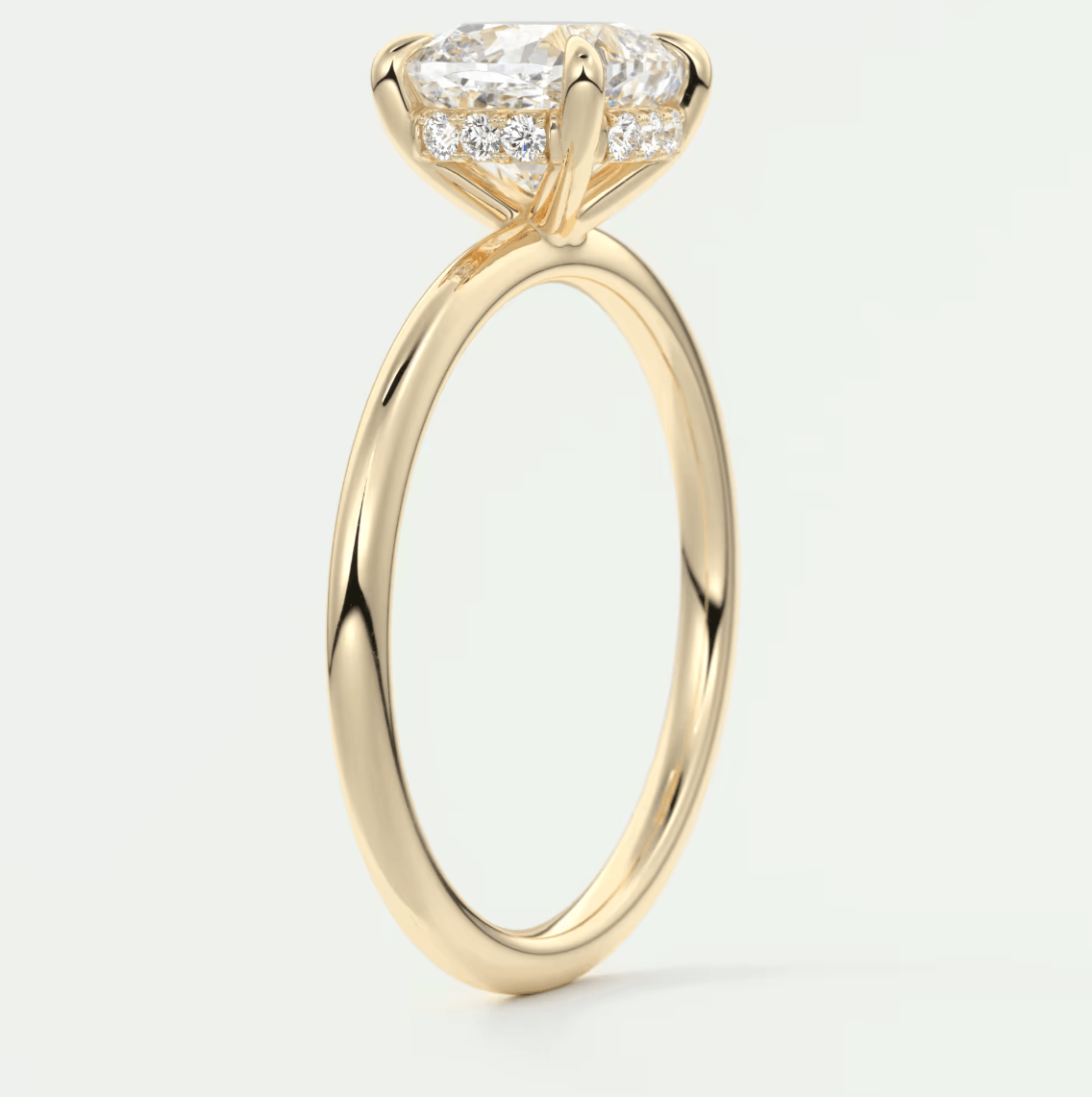 18-karat yellow gold engagement ring with a princess-cut diamond center stone and smaller diamonds on the band.