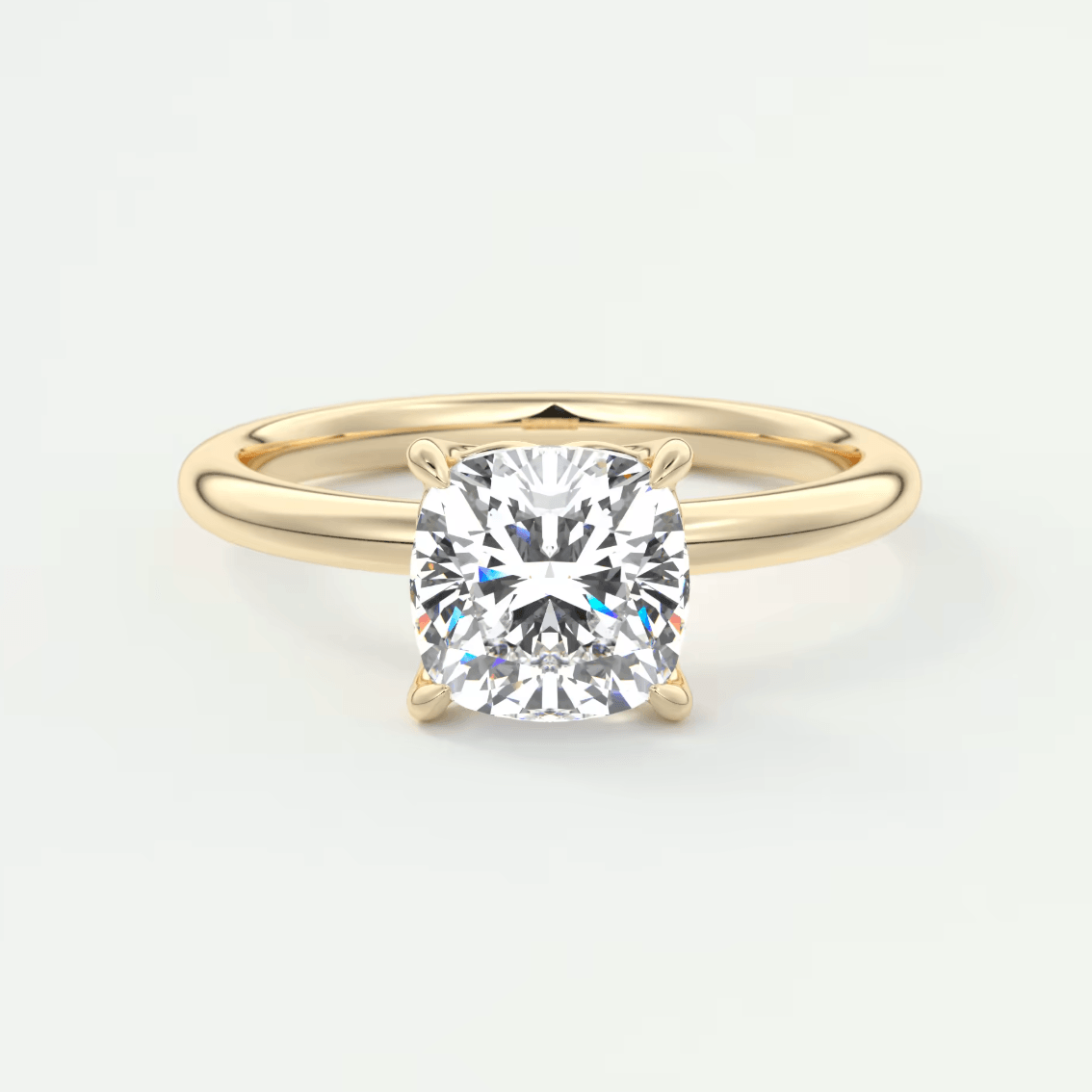 18-karat gold cushion-cut diamond engagement ring.
