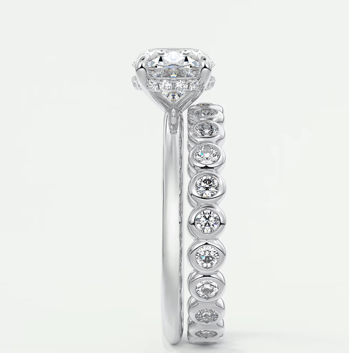 18k white gold diamond engagement ring with a round center stone and six smaller diamonds on the band.