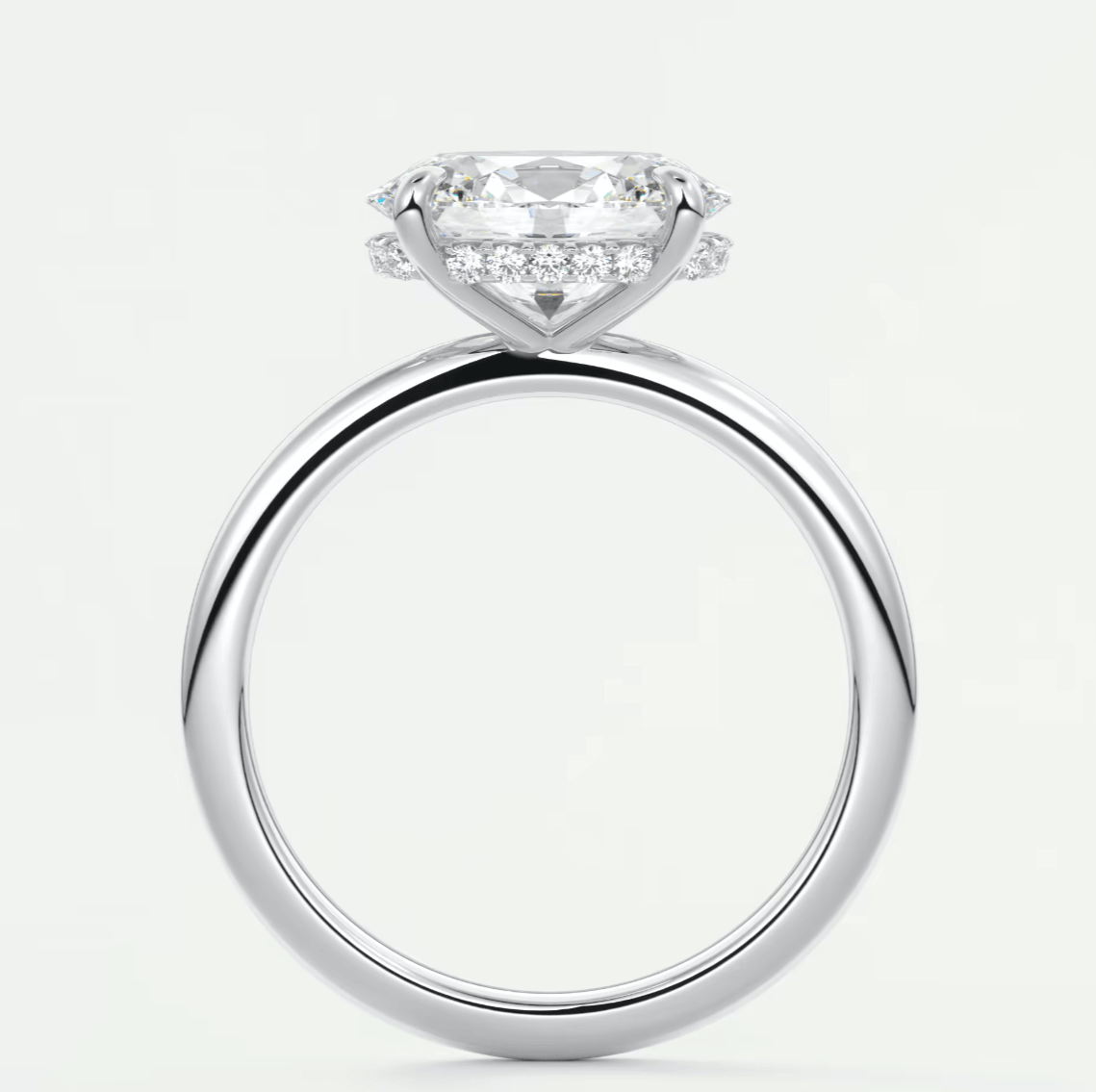 18-karat white gold engagement ring with a cushion-cut diamond and halo of smaller diamonds.