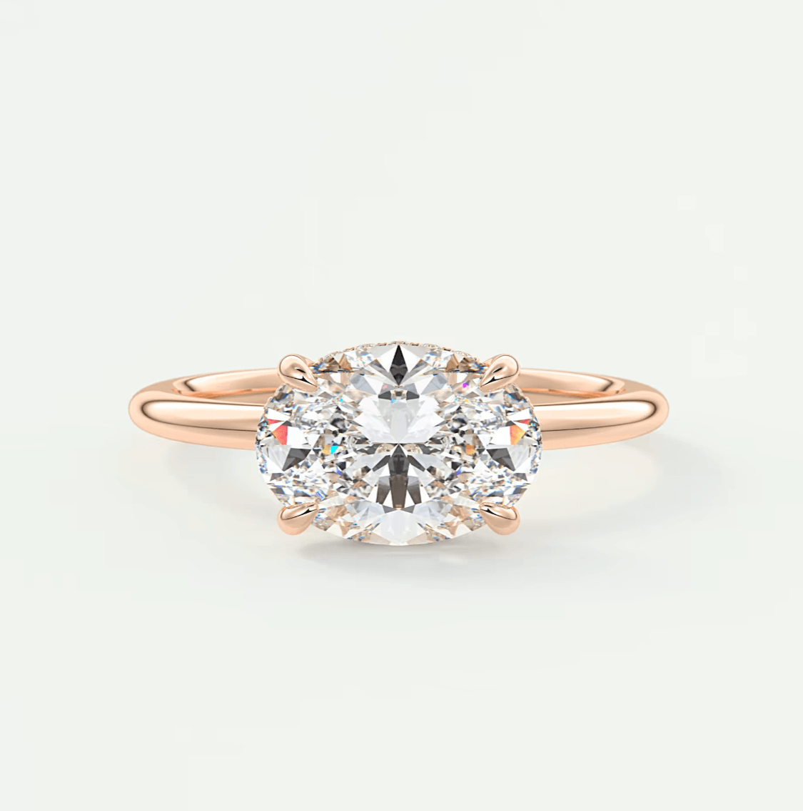Rose gold diamond engagement ring with a cushion-cut center stone and three prongs.
