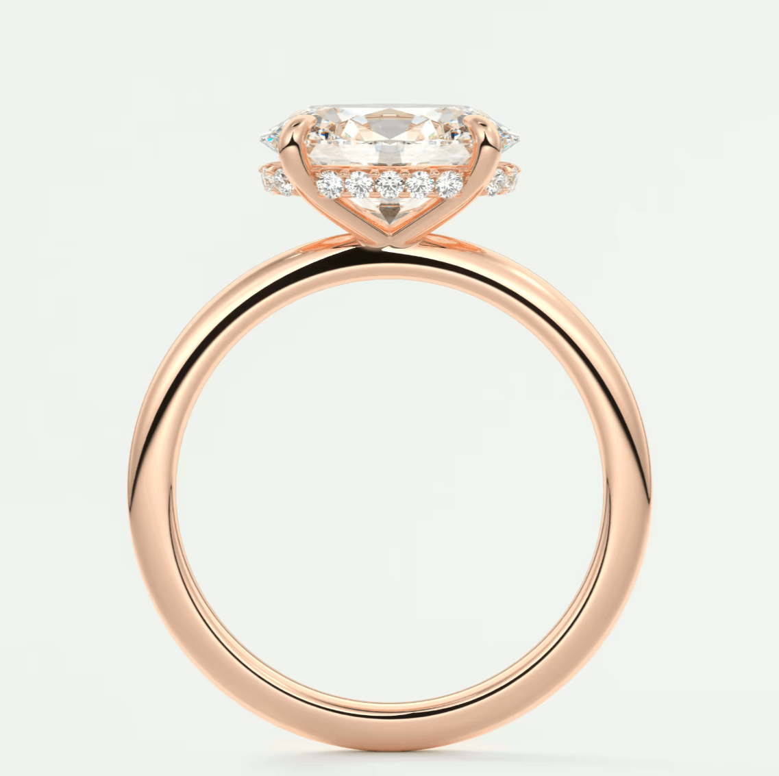 18k rose gold engagement ring with a cushion-cut diamond and halo of smaller diamonds.