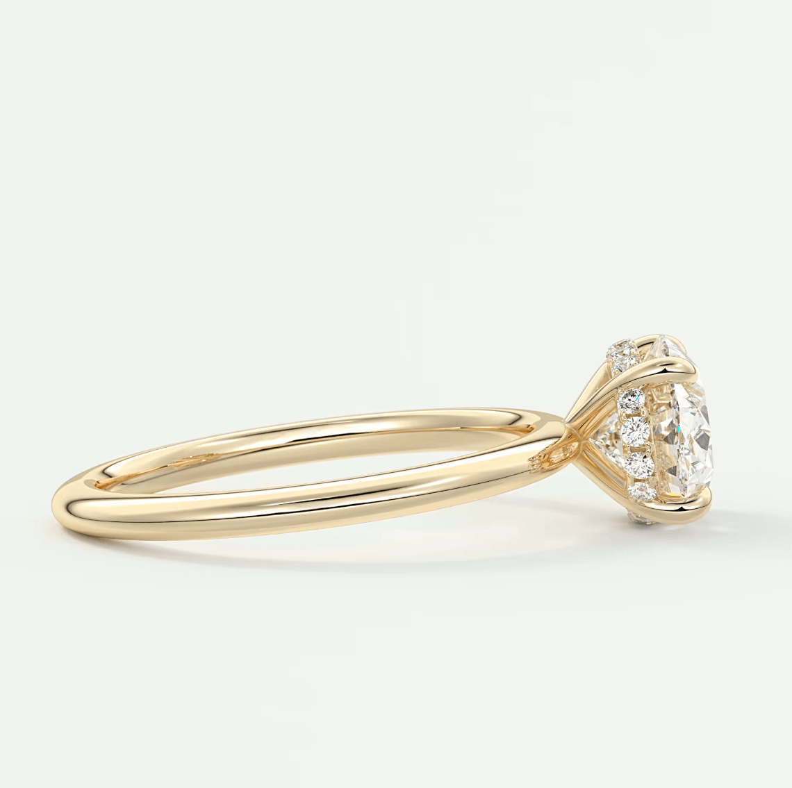 18k gold diamond engagement ring with a cushion-cut center stone and small side diamonds.