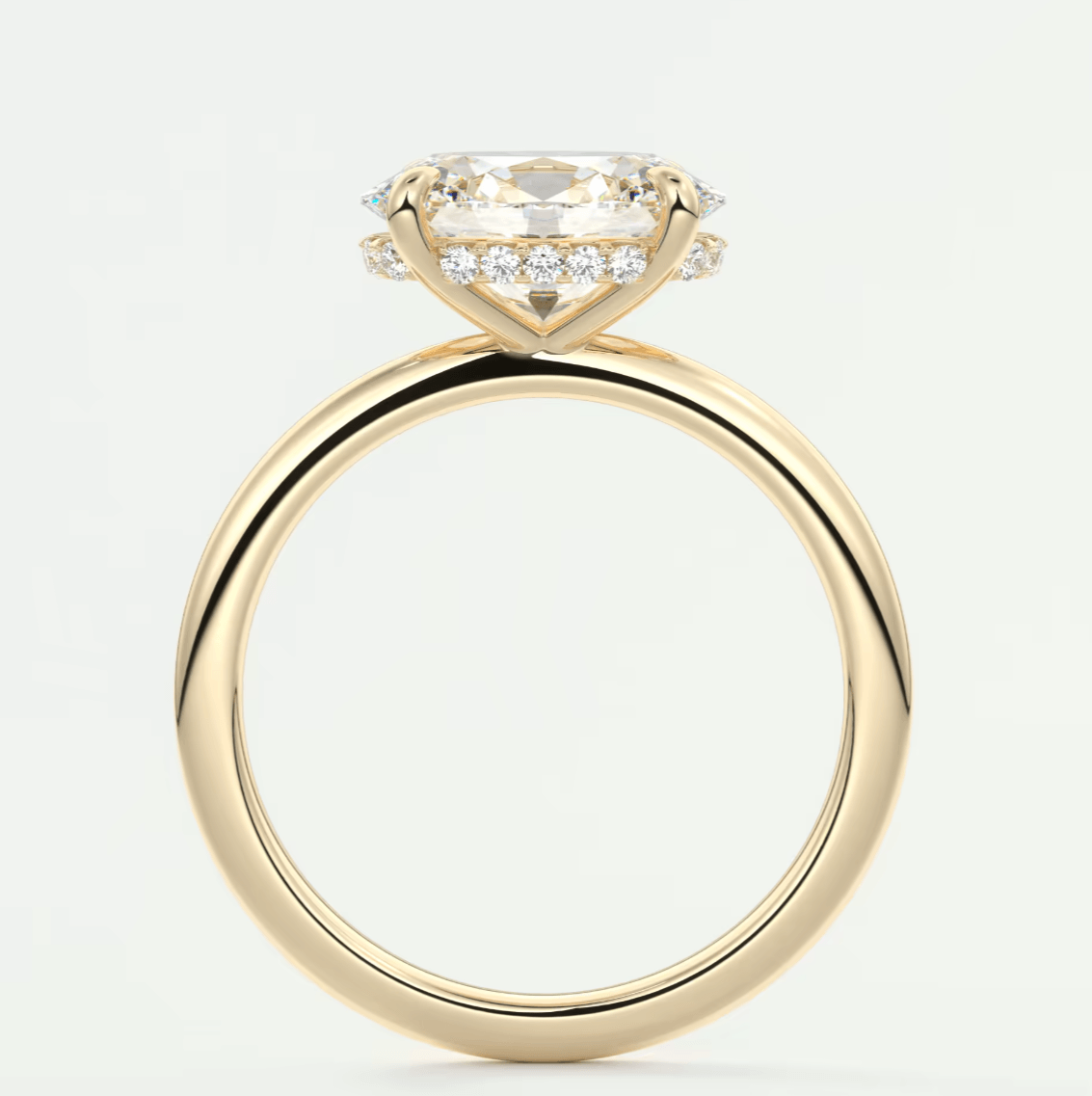 18k yellow gold engagement ring with a cushion-cut diamond and halo of smaller diamonds.