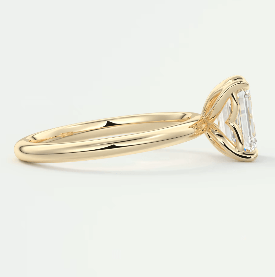 18k yellow gold emerald-cut diamond engagement ring.