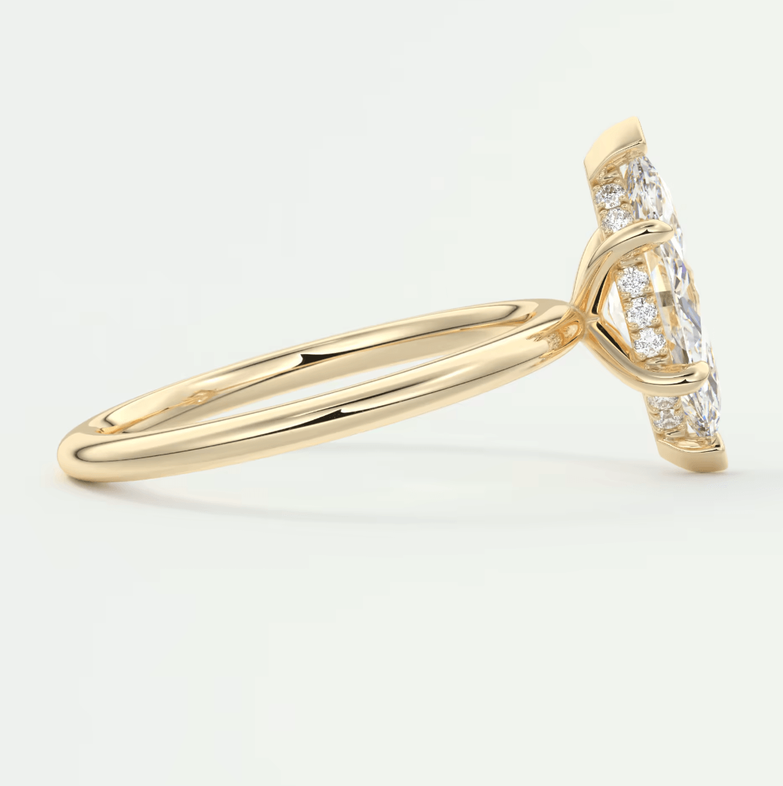 18k yellow gold diamond engagement ring with a marquise-cut center stone and pave-set diamonds on the band.
