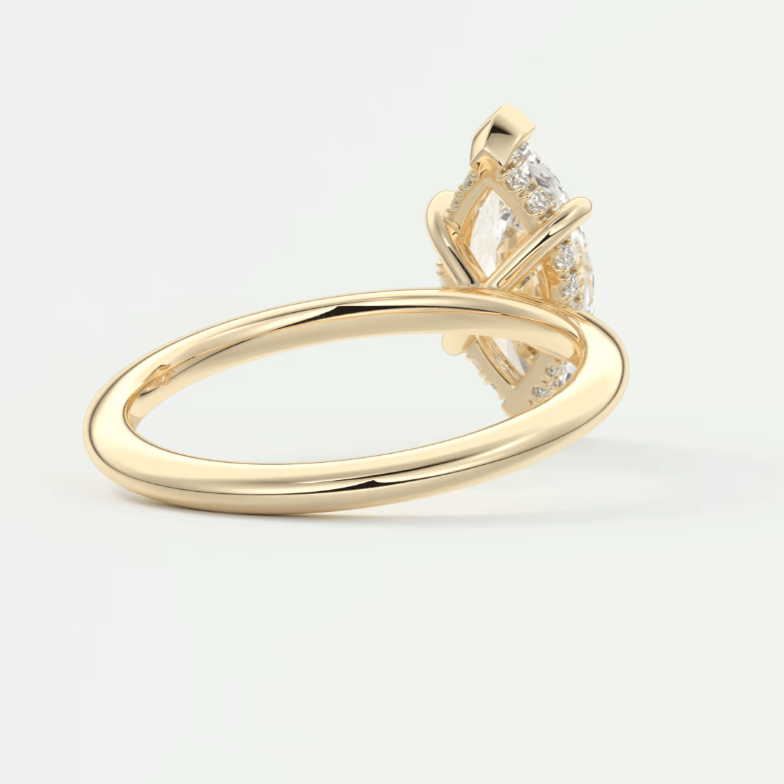 18k yellow gold engagement ring with a marquise-cut diamond and small accent diamonds.