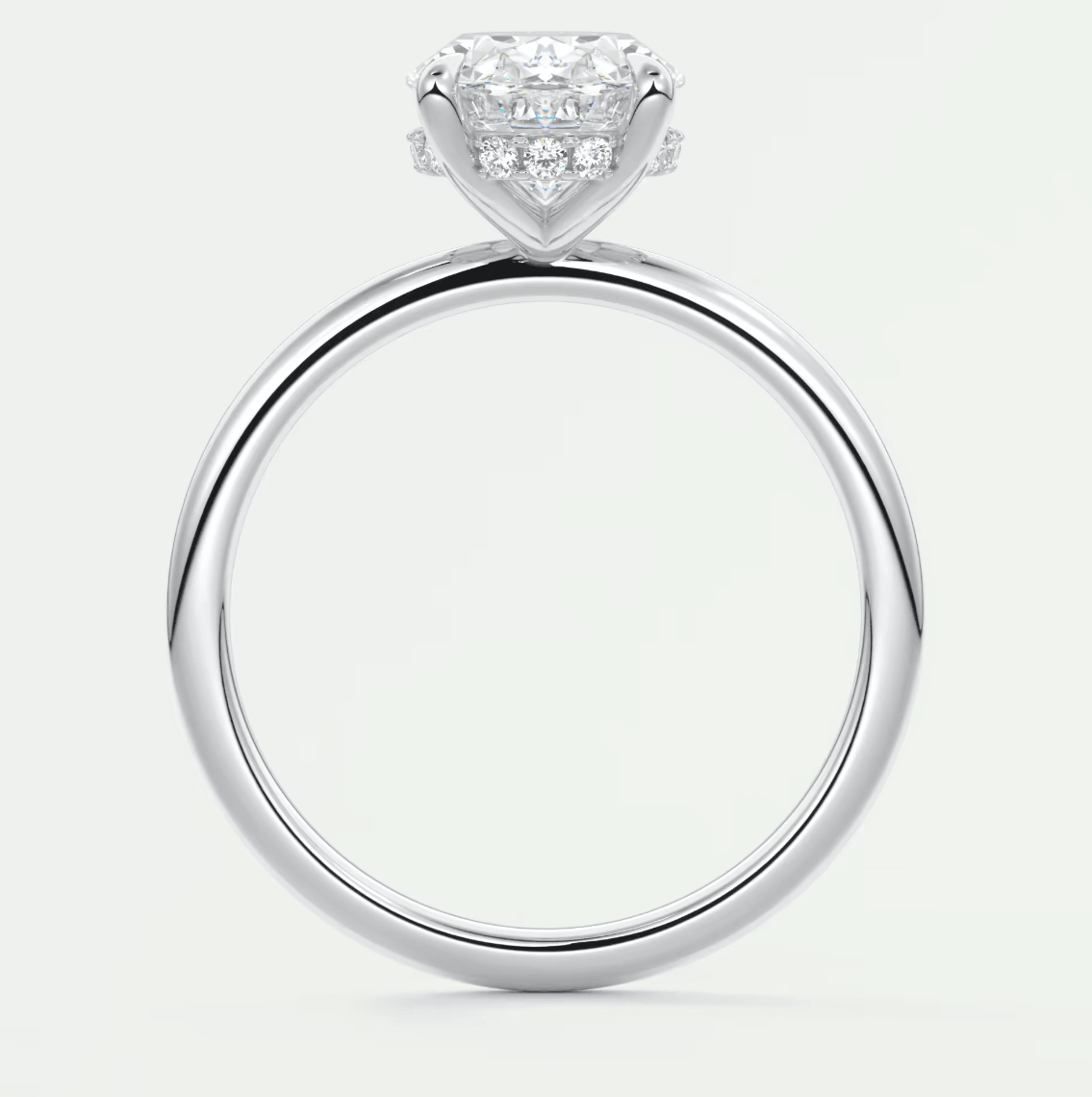 18-karat white gold engagement ring with a princess-cut diamond center stone and small round diamonds on the band.