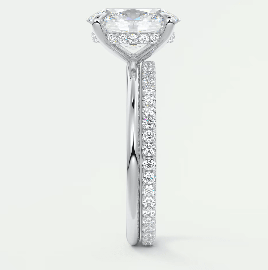 18-karat white gold engagement ring with a marquise-cut diamond and pavé set diamonds on the band.