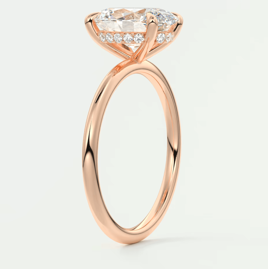 18-karat rose gold engagement ring with a marquise-cut diamond and pavé-set diamonds on the band.
