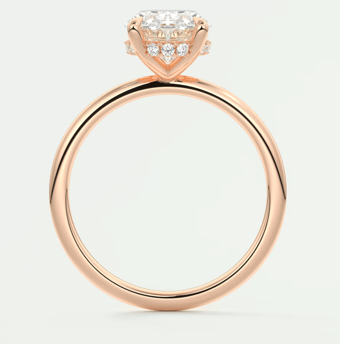 18k rose gold engagement ring with a princess cut diamond and small diamonds on the band.