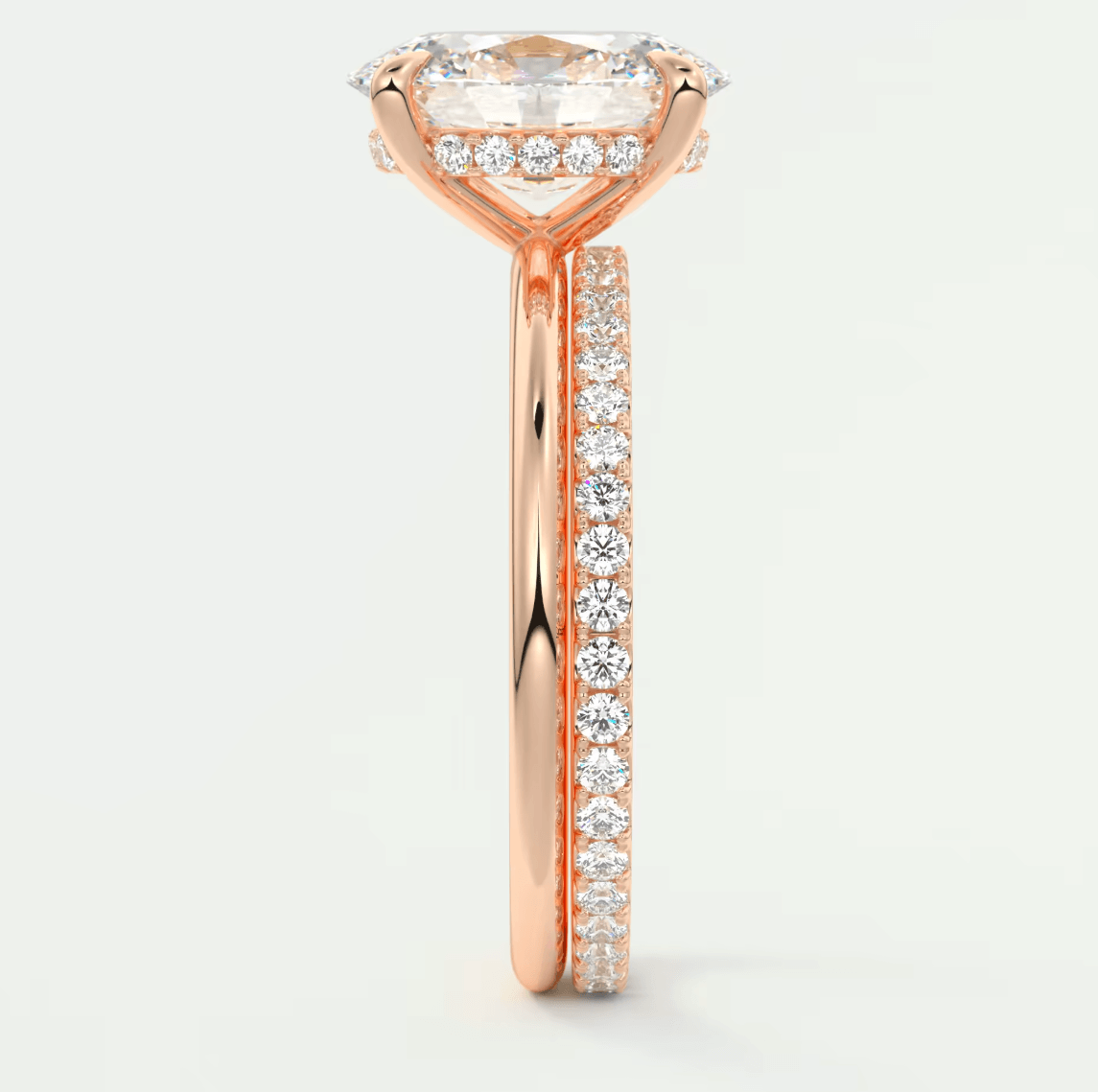 18-karat rose gold engagement ring with a marquise-cut diamond center stone and pave-set diamonds on the band.