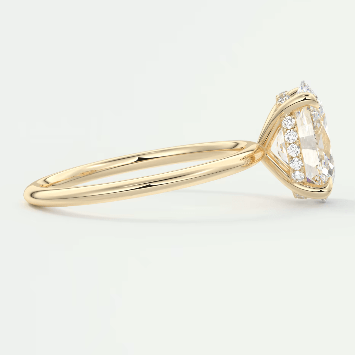 18k yellow gold diamond engagement ring with a marquise-cut center stone and small diamonds on the band.