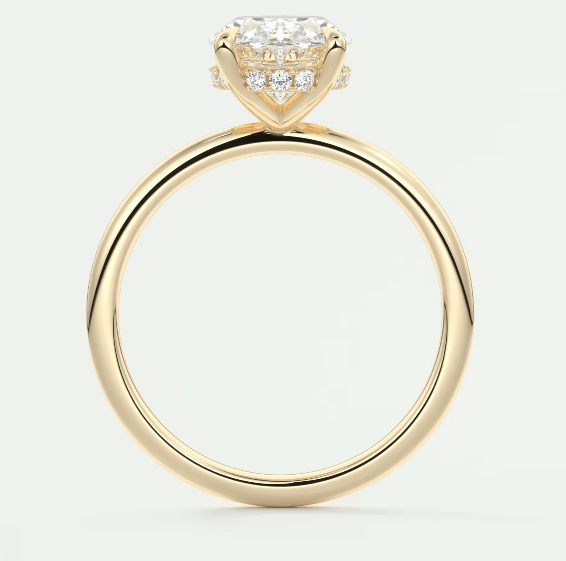 18-karat yellow gold engagement ring with a princess-cut diamond center stone and small pavé diamonds on the band.