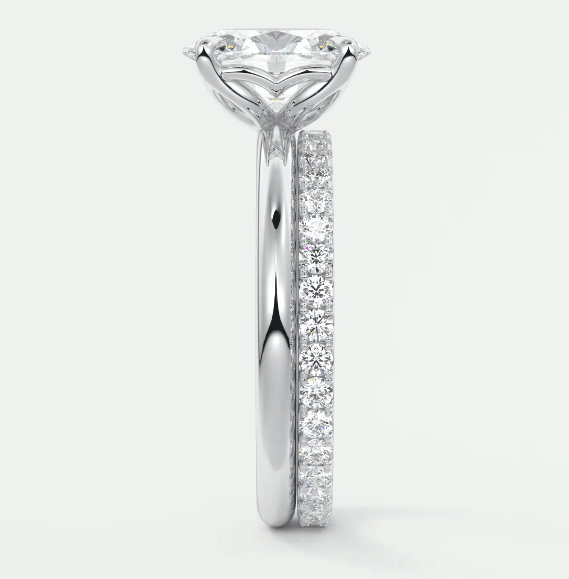 18k white gold diamond engagement ring with a solitaire center stone and pavé set diamonds on the band.