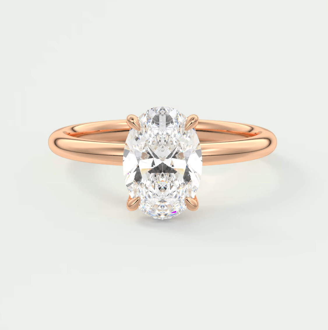 18-karat rose gold engagement ring with a cushion-cut diamond.