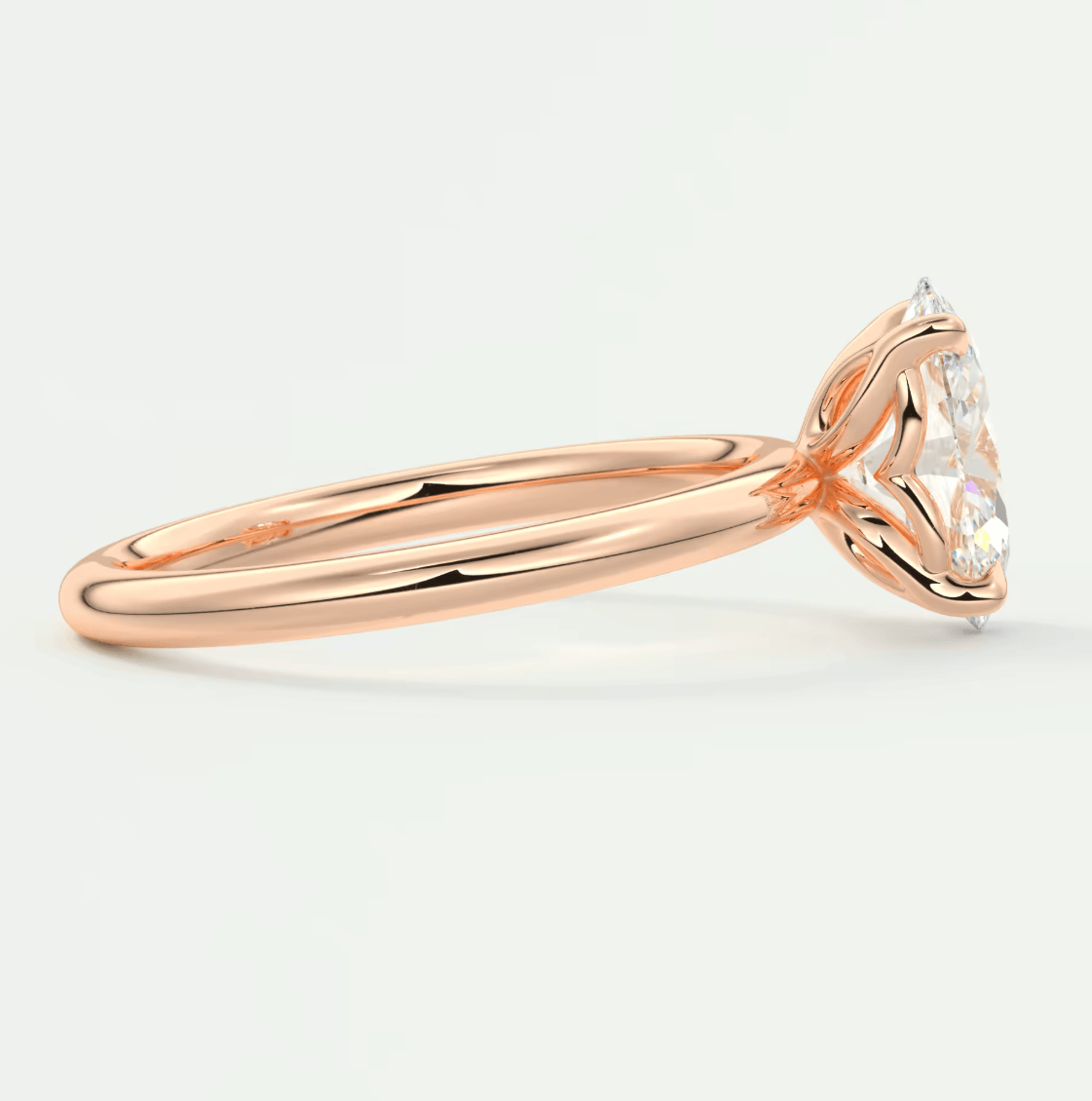 18-karat rose gold engagement ring with a princess-cut diamond and two smaller diamonds on either side, featuring an elegant heart-shaped setting.