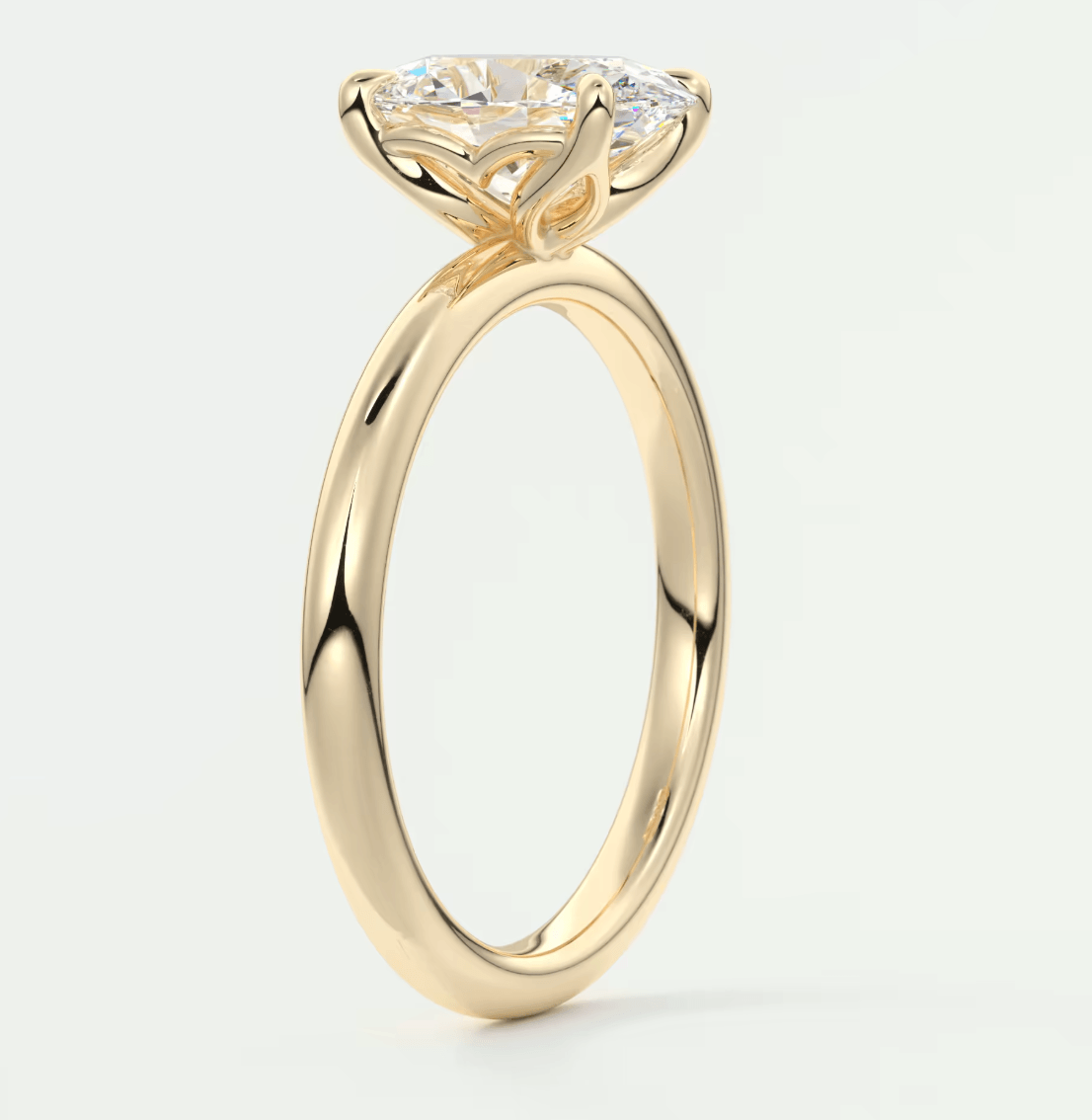 18-karat yellow gold solitaire engagement ring with a round diamond.