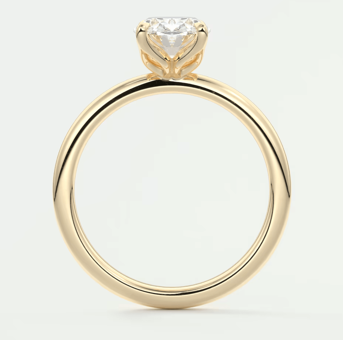 18-karat yellow gold engagement ring with a heart-shaped diamond.