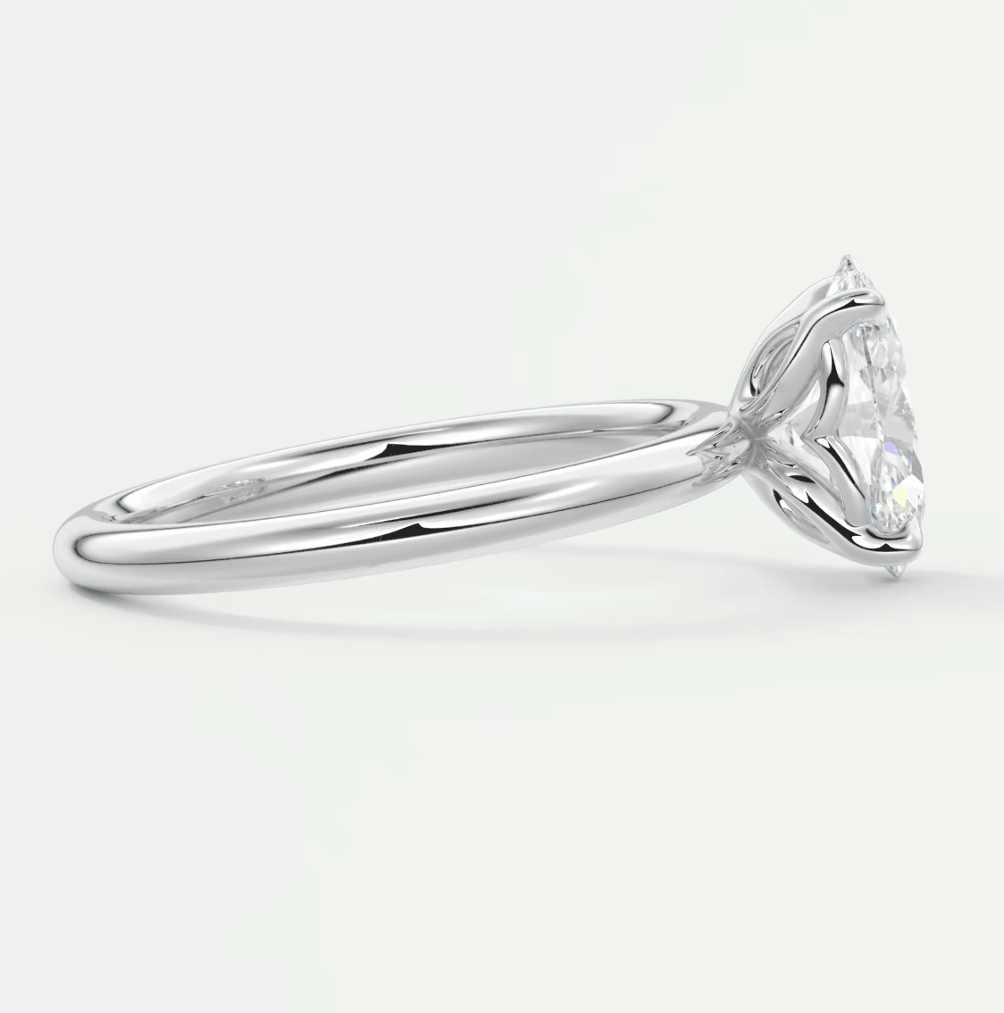 White gold solitaire diamond engagement ring with a marquise-shaped stone.