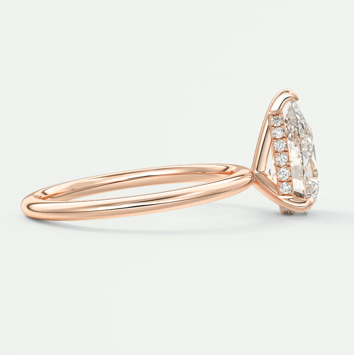Rose gold marquise diamond engagement ring with halo design and side stones
