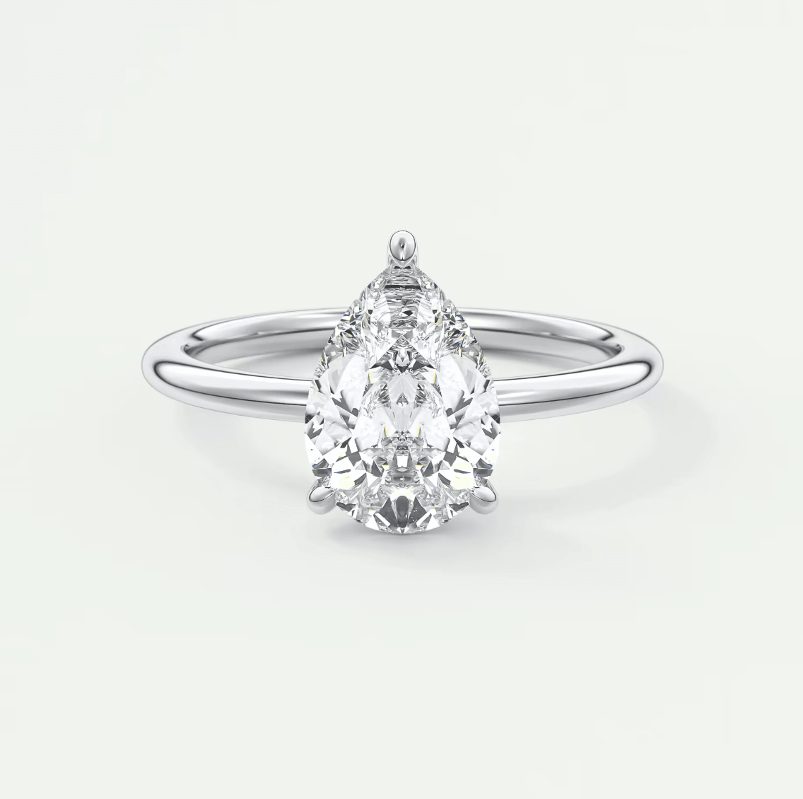 Pear-shaped diamond engagement ring with white gold band and prong setting.