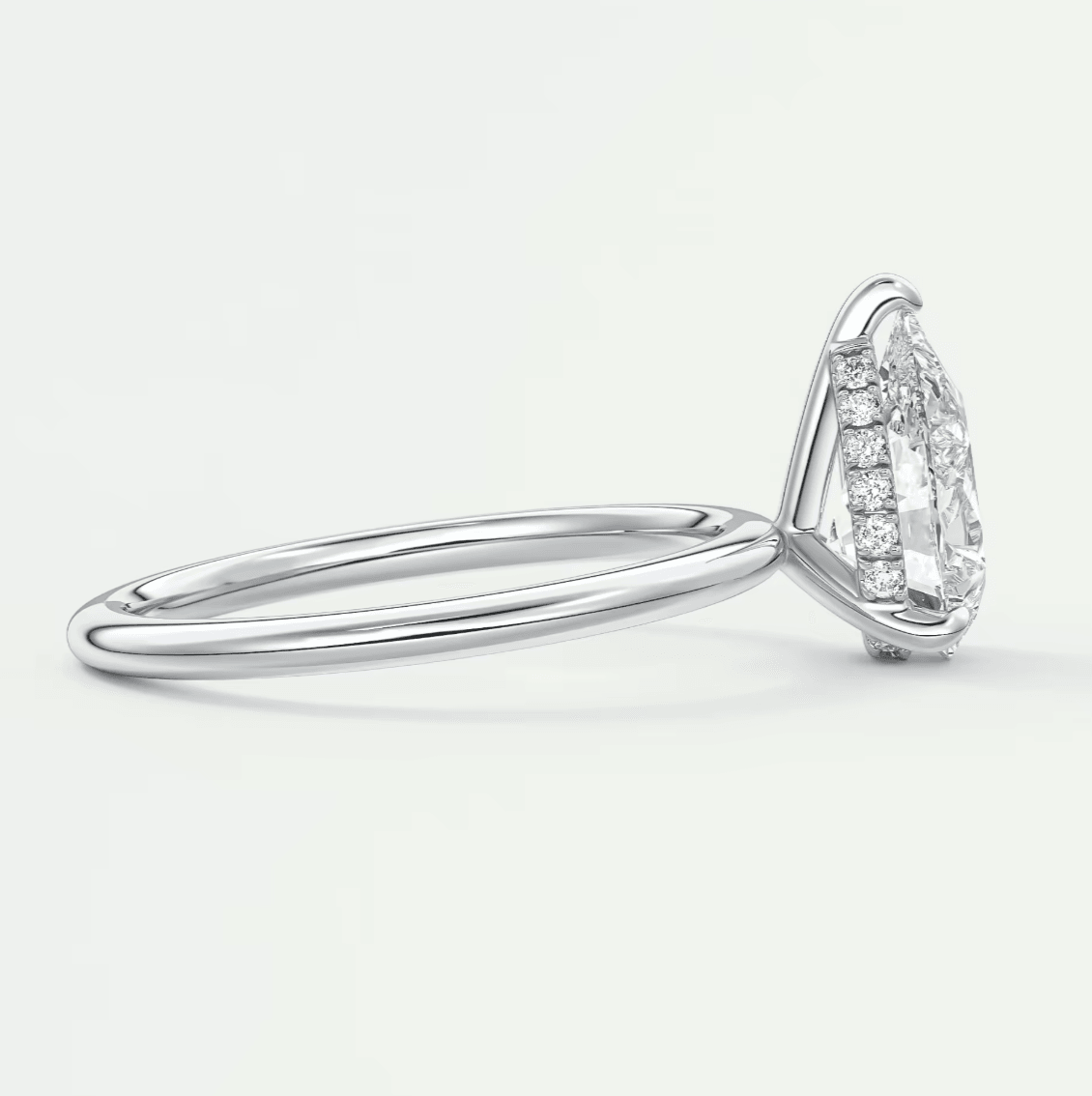 18k white gold diamond engagement ring with a marquise-cut center stone and halo of smaller diamonds.