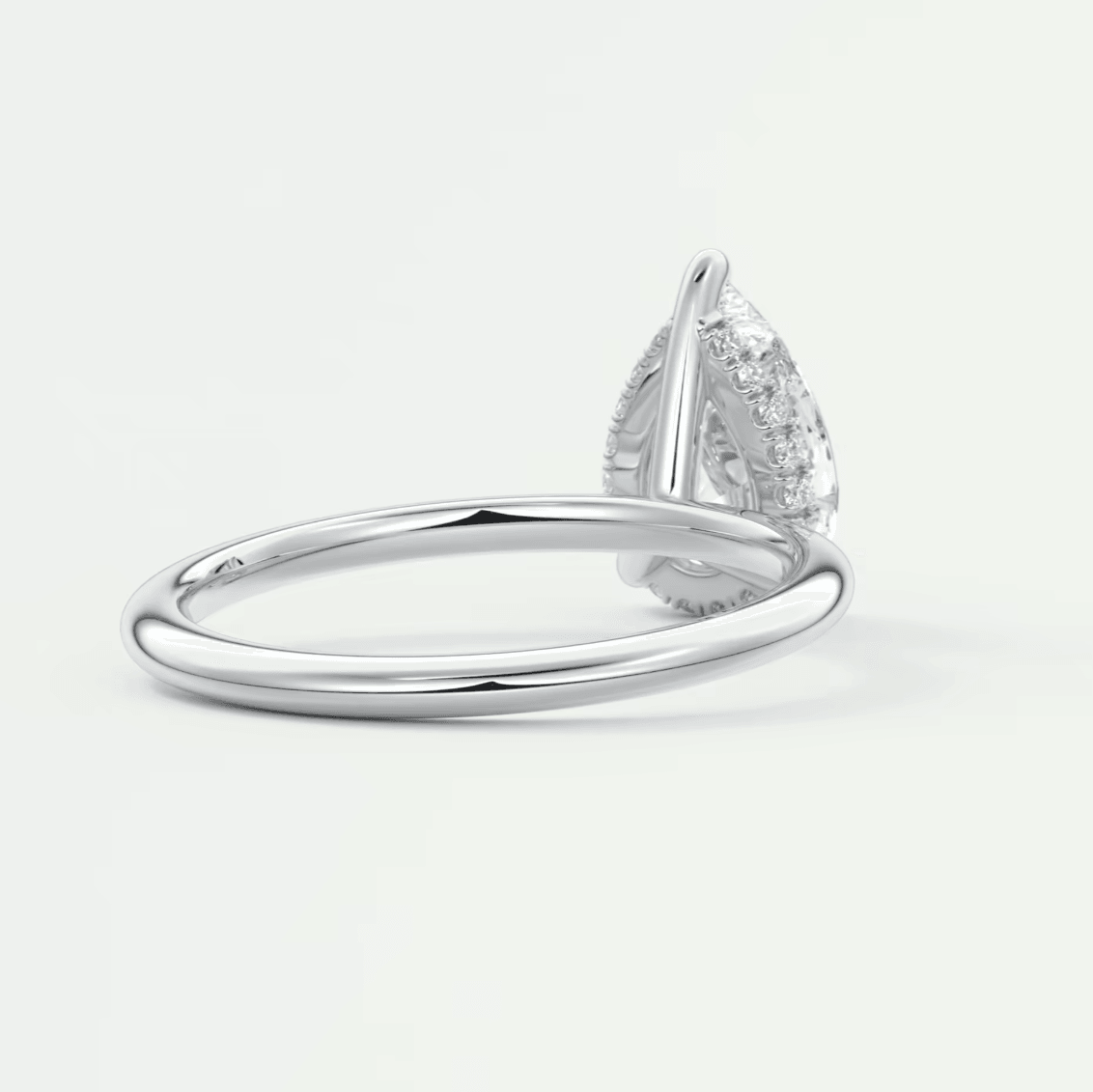 Pear-shaped diamond engagement ring with a white gold band and prong setting.