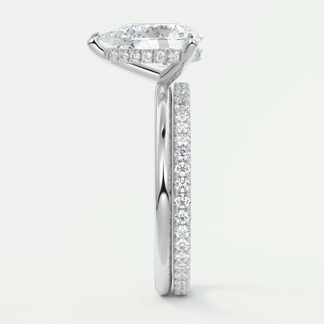 18k white gold diamond engagement ring with a marquise-cut center stone and pavé-set diamonds on the band.