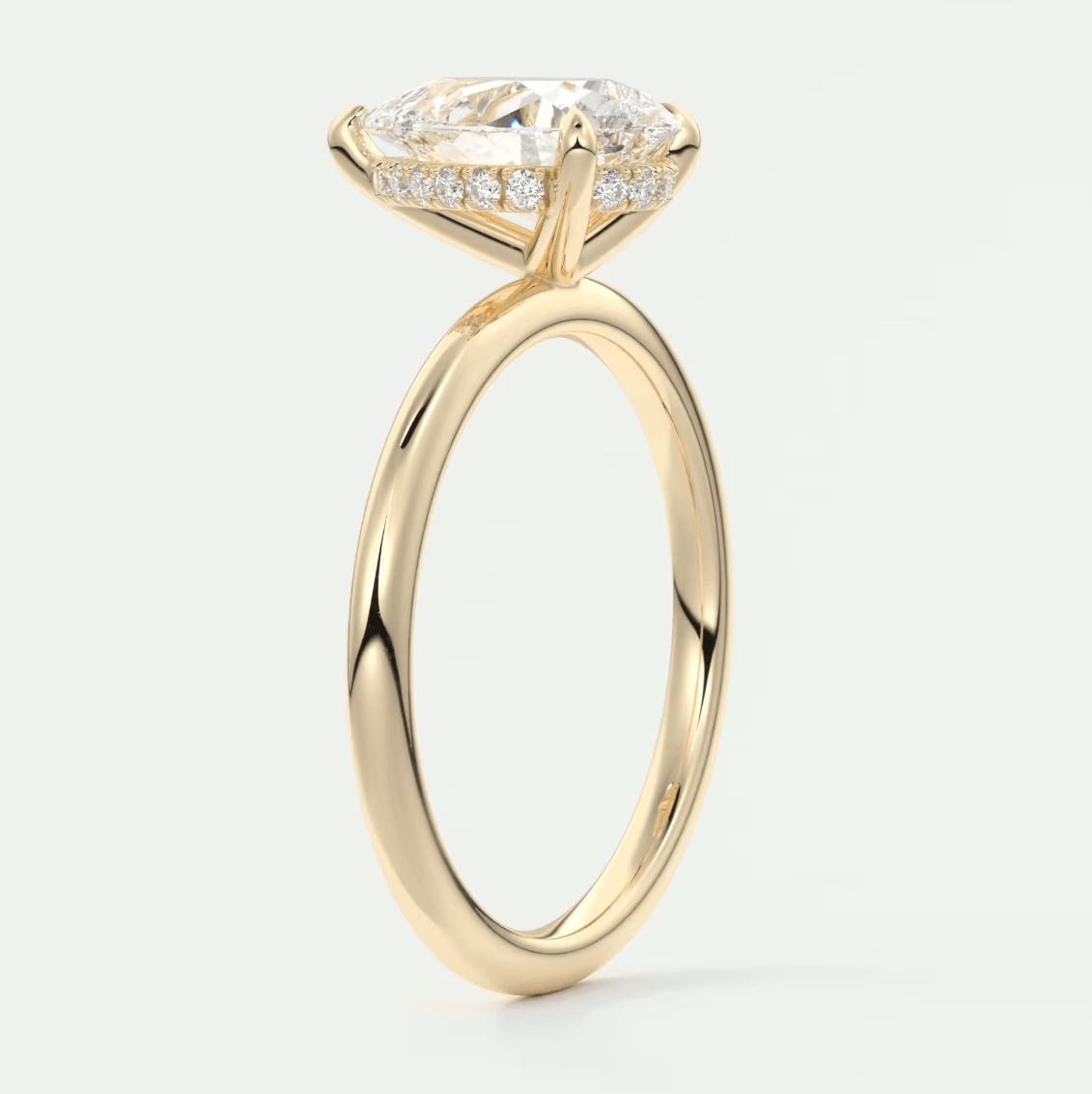 18-karat yellow gold engagement ring with a marquise-cut diamond and pavé set diamonds on the band.