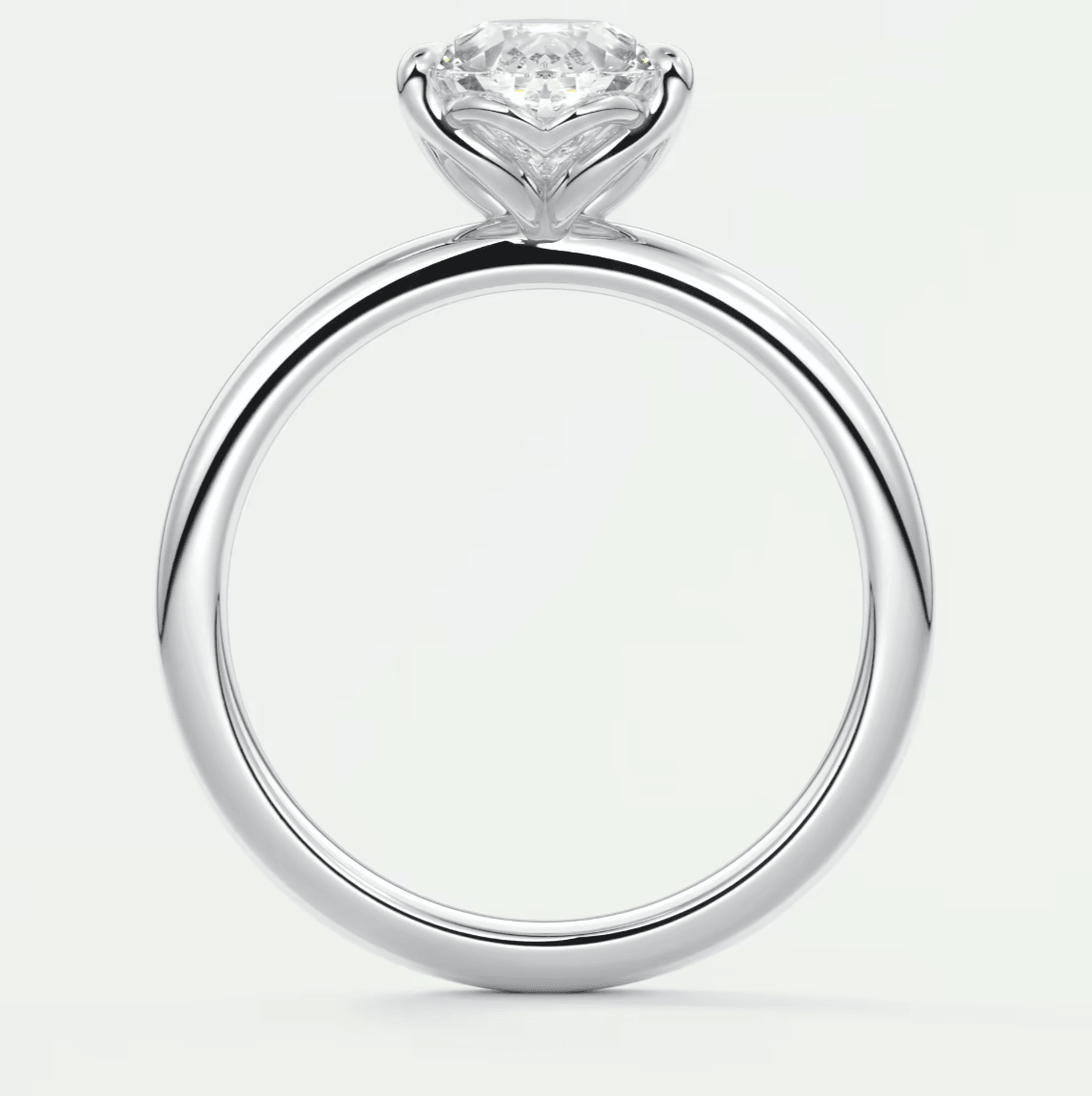 18-karat white gold engagement ring with a round diamond center stone and pave-set diamonds on the band.