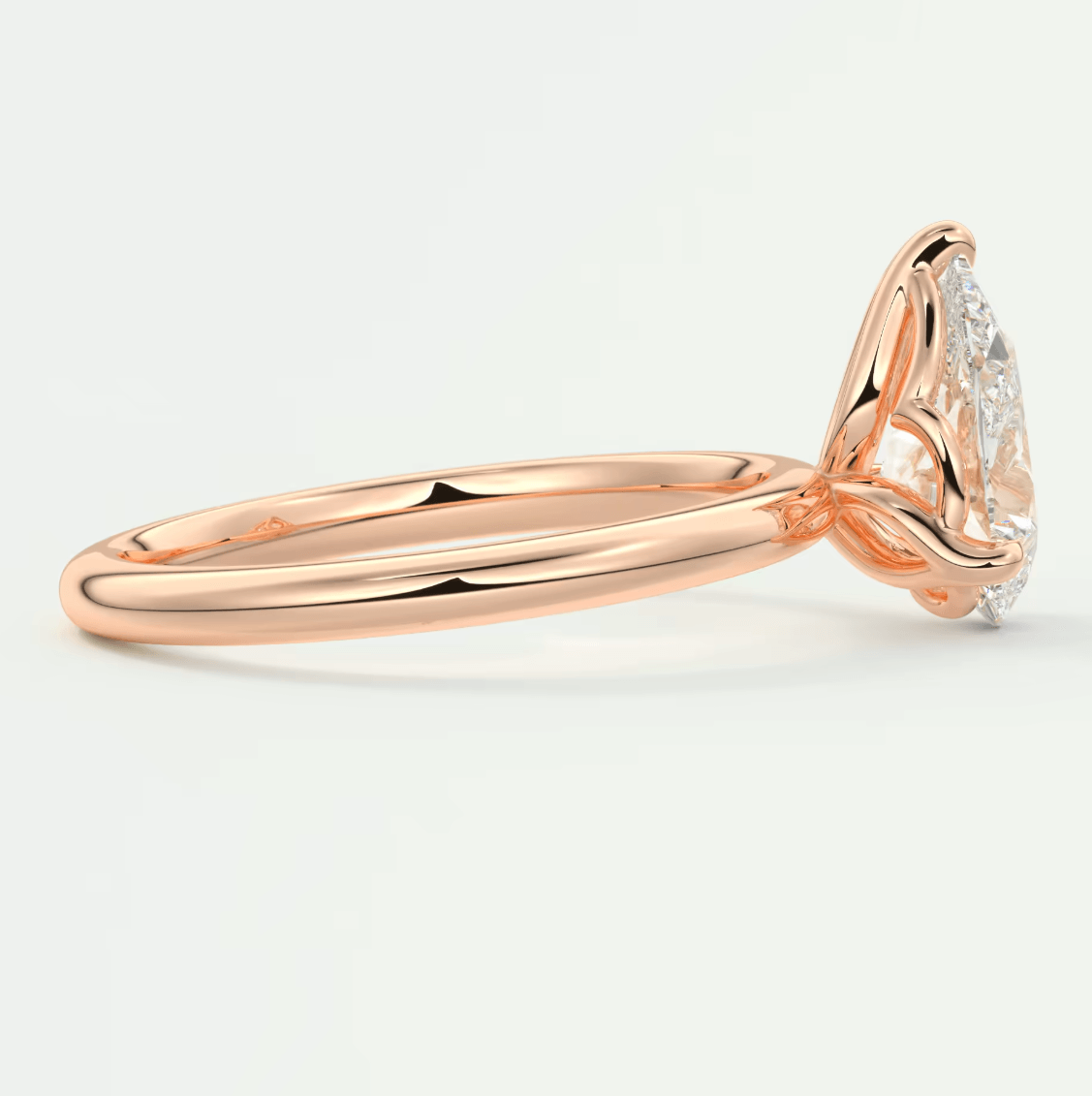 18-karat rose gold engagement ring with a princess-cut diamond.