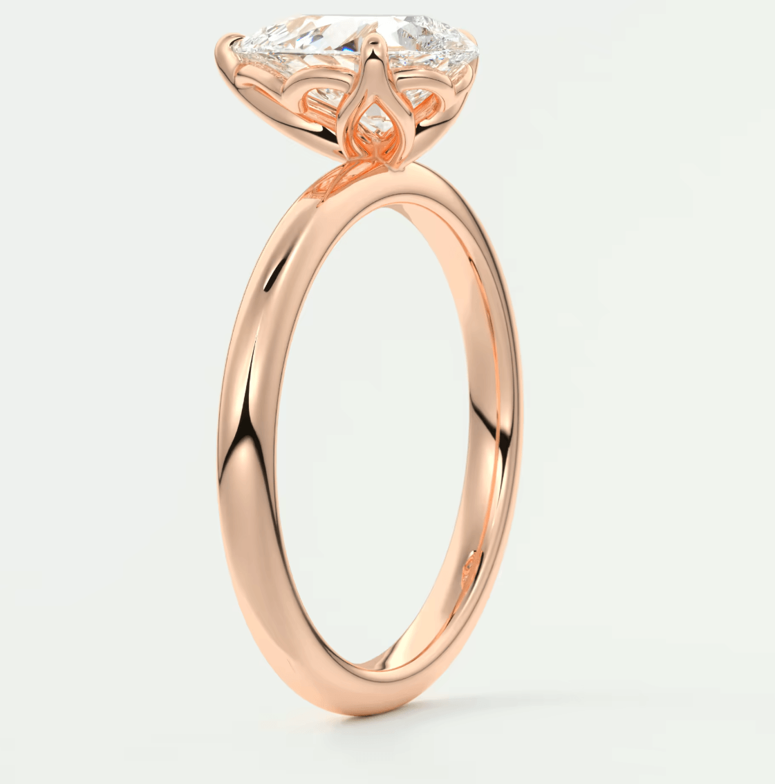 Rose gold engagement ring with a large, cushion-cut diamond.