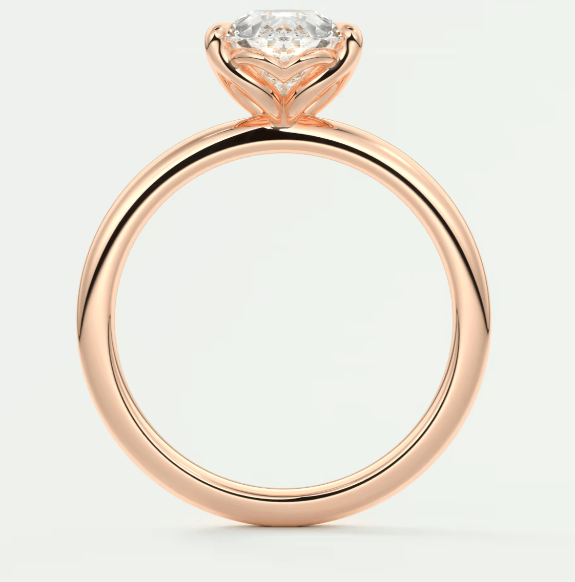Rose gold diamond engagement ring with a solitaire design and cushion-cut gemstone.